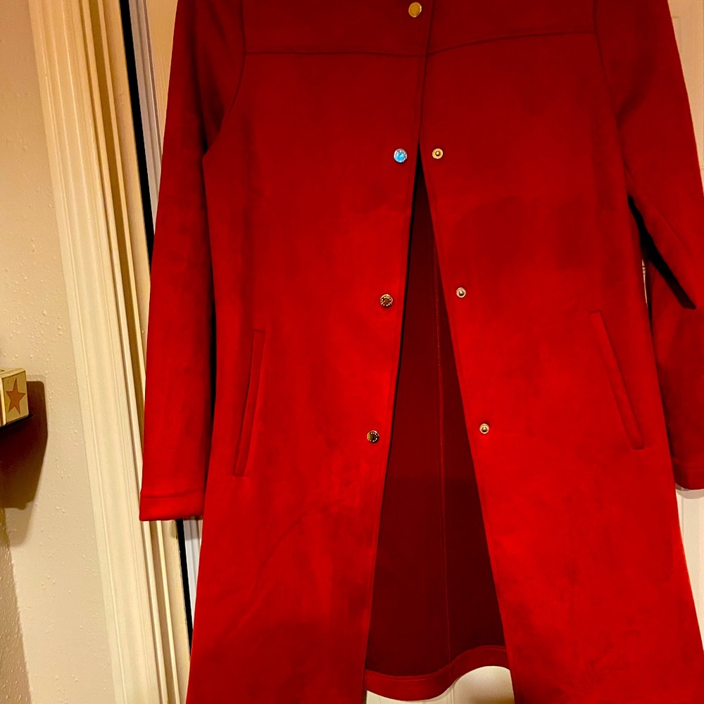 coat is a light weight to the knee burnt orange In  a soft ultra suede fabric